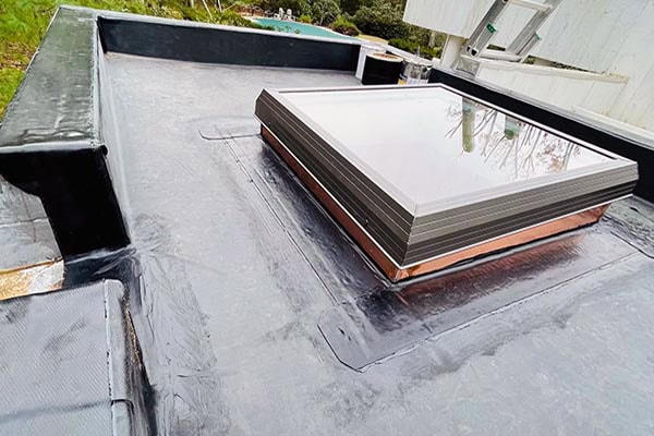 Roofing and chimney installation on a flat commercial roof in Long Island, NY.