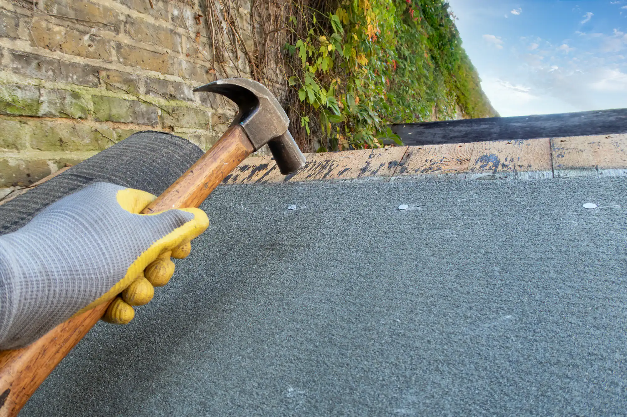 Roofing and chimney repair work being performed by a professional contractor in Long Island, NY.