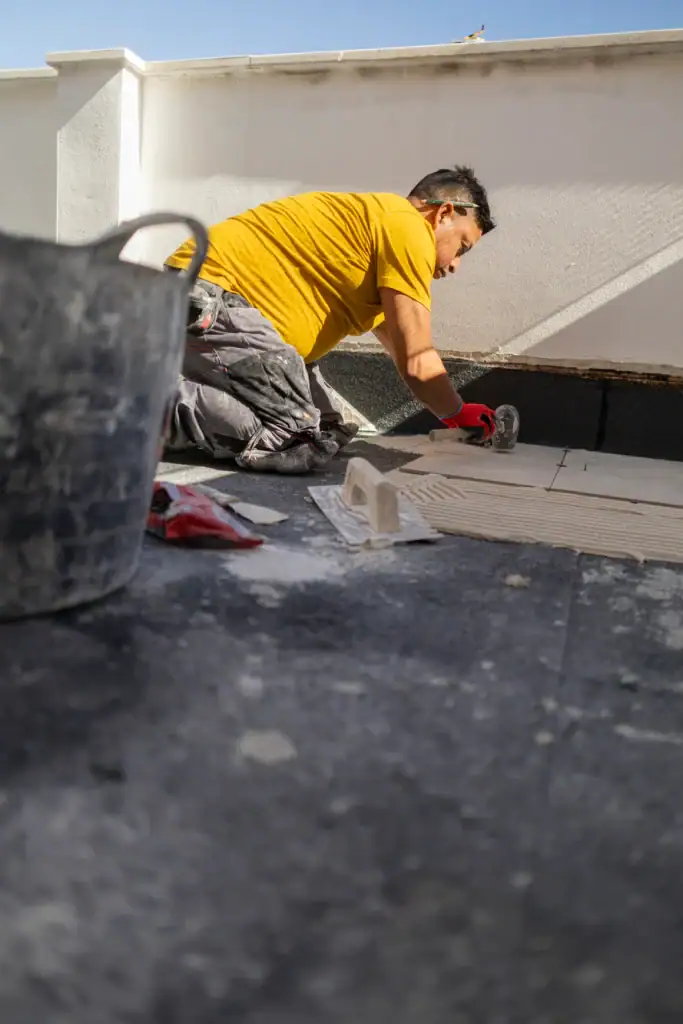 Roofing and chimney repair work being performed by a professional contractor in Long Island, NY.