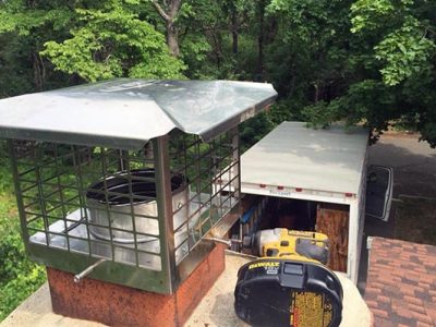 Chimney cap installation on a residential roof in Long Island, NY.