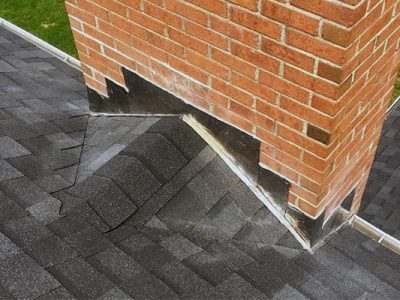 Roofing & chimney flashing repair on a brick chimney in Long Island, NY.